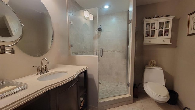 bathroom featuring vanity, tile patterned floors, a stall shower, and toilet