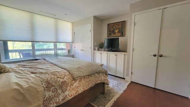 bedroom with wood finished floors and visible vents