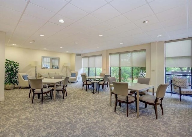 dining space featuring carpet floors, recessed lighting, and a paneled ceiling