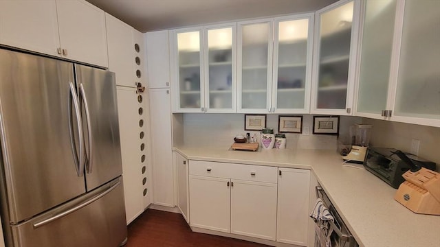 kitchen with light countertops, glass insert cabinets, white cabinets, and freestanding refrigerator