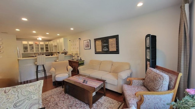 living room with recessed lighting, baseboards, and wood finished floors