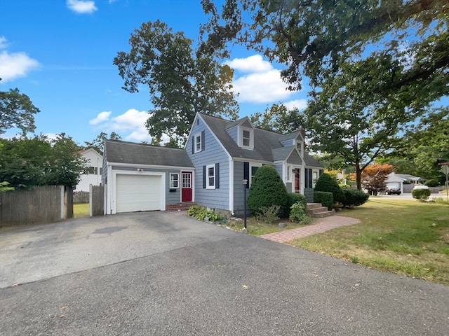 view of front of property with a garage and a front lawn