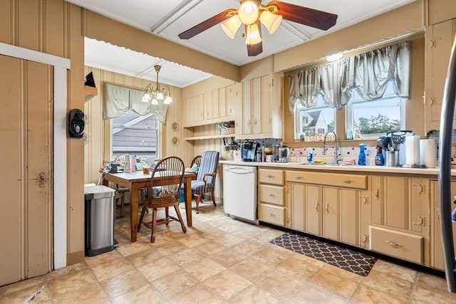 kitchen with dishwasher, a sink, ceiling fan, ornamental molding, and light countertops