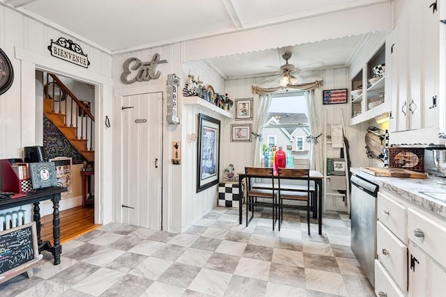 kitchen with a ceiling fan, ornamental molding, white cabinetry, and stainless steel dishwasher