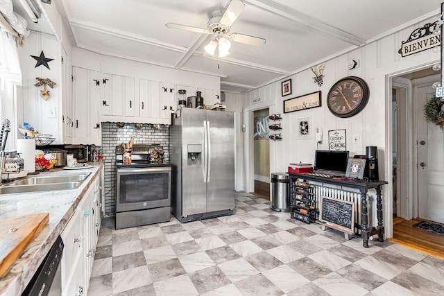 kitchen featuring stainless steel appliances, a ceiling fan, tasteful backsplash, white cabinetry, and light countertops