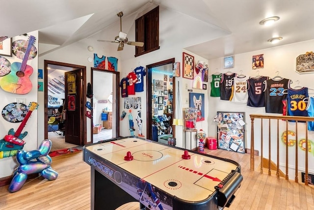 recreation room featuring hardwood / wood-style flooring, ceiling fan, and lofted ceiling