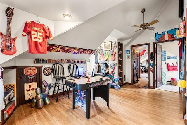 playroom with wood finished floors, lofted ceiling, a ceiling fan, and baseboards