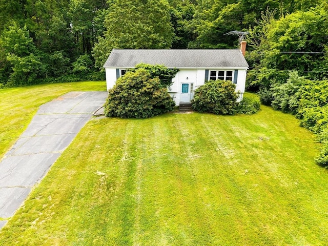 79 Chapel St, Gardner, MA 01440 - view of front of house with a front lawn, a chimney, a forest view, and asphalt driveway