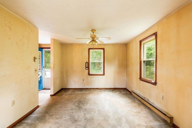 79 Chapel St, Gardner, MA 01440 - carpeted empty room with a baseboard heating unit, healthy amount of natural light, and a ceiling fan