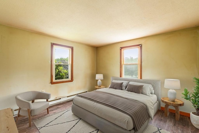 79 Chapel St, Gardner, MA 01440 - bedroom with baseboard heating, wood finished floors, and a textured ceiling