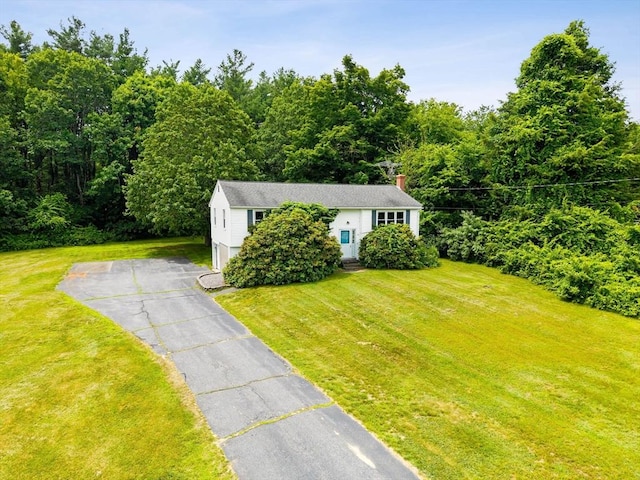 79 Chapel St, Gardner, MA 01440 - view of front of home with asphalt driveway, a front lawn, and a chimney