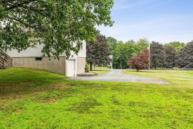 79 Chapel St, Gardner, MA 01440 - view of green lawn with driveway and a garage