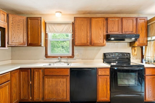 79 Chapel St, Gardner, MA 01440 - kitchen with black appliances, under cabinet range hood, light countertops, and brown cabinets
