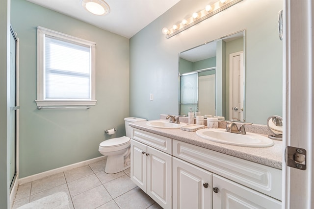 bathroom with vanity, toilet, an enclosed shower, and tile patterned floors