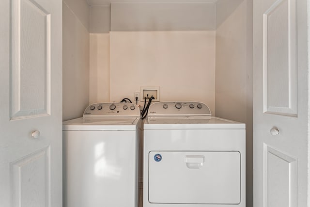 clothes washing area with washing machine and dryer