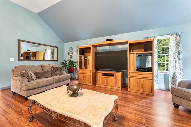 living room featuring light wood-type flooring and lofted ceiling