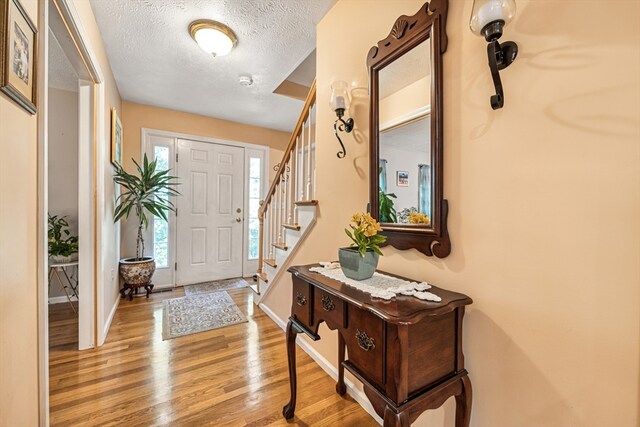 foyer featuring light hardwood / wood-style flooring and a textured ceiling