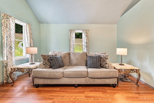 living room with vaulted ceiling and a wealth of natural light