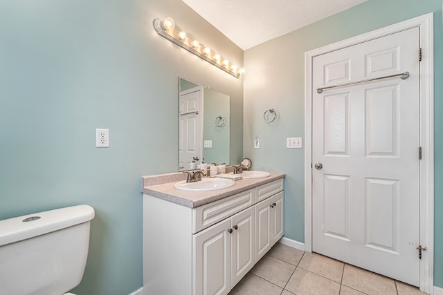 bathroom featuring tile patterned floors, a textured ceiling, vanity, and toilet