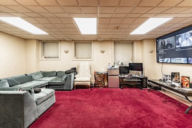 carpeted living room with a drop ceiling