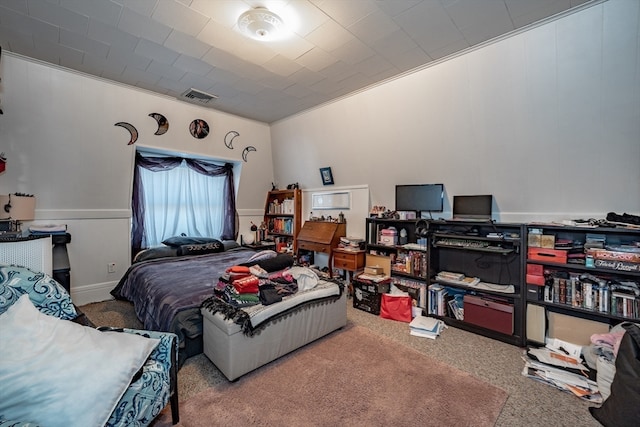 carpeted bedroom with ornamental molding