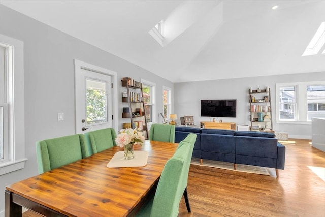 72 Rawson Rd Unit 2, Arlington, MA 02474 - dining space featuring a skylight, healthy amount of natural light, lofted ceiling, wood finished floors, and baseboards