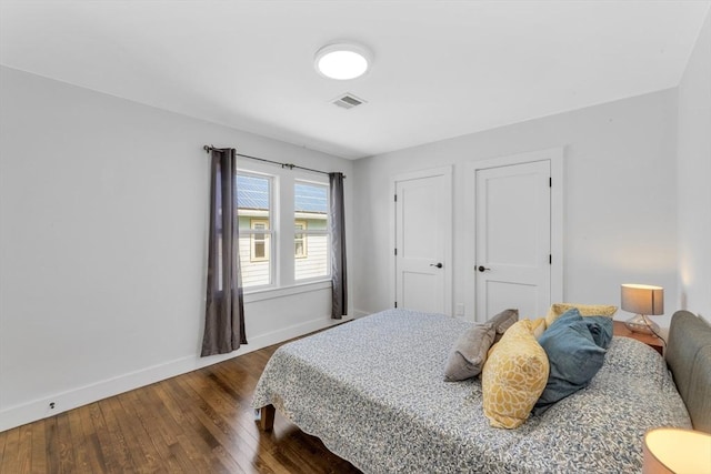 72 Rawson Rd Unit 2, Arlington, MA 02474 - bedroom featuring baseboards and dark wood-style flooring