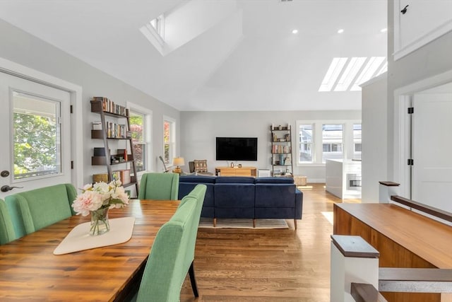 72 Rawson Rd Unit 2, Arlington, MA 02474 - dining area featuring a skylight, plenty of natural light, light wood-style floors, high vaulted ceiling, and recessed lighting