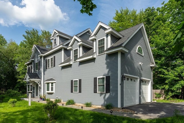 16 Border Rd, Reading, MA 01867 - view of home's exterior featuring asphalt driveway, an attached garage, a shingled roof, and a lawn