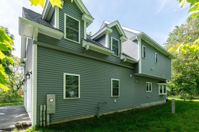 16 Border Rd, Reading, MA 01867 - view of home's exterior featuring a garage and a lawn
