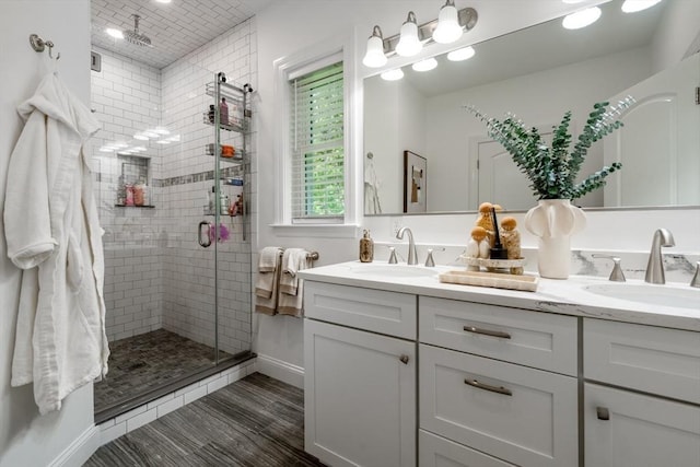 16 Border Rd, Reading, MA 01867 - full bath featuring double vanity, a shower stall, wood finished floors, and recessed lighting