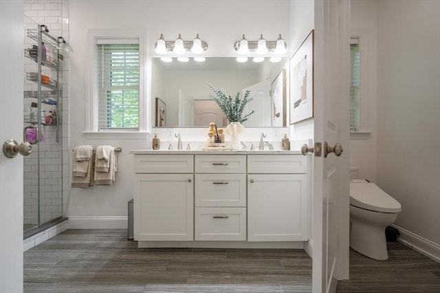 16 Border Rd, Reading, MA 01867 - bathroom featuring double vanity, a shower stall, and wood finished floors