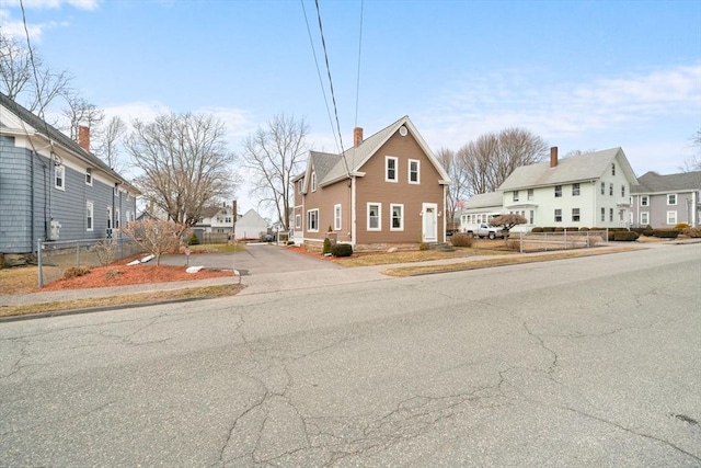 view of front of property featuring a residential view and a chimney