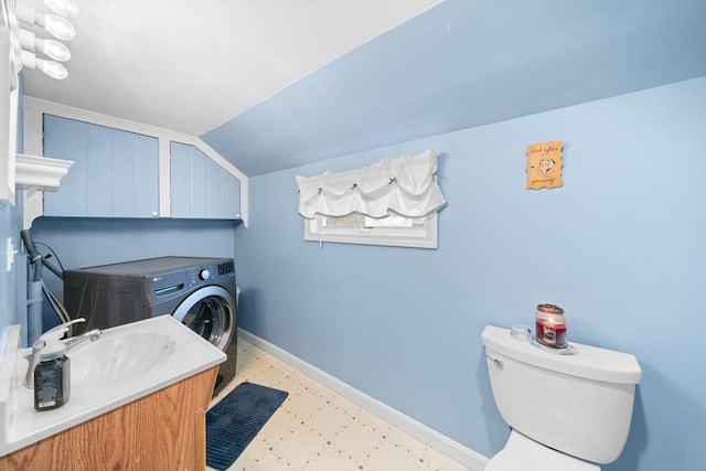 laundry area with laundry area, baseboards, and a sink