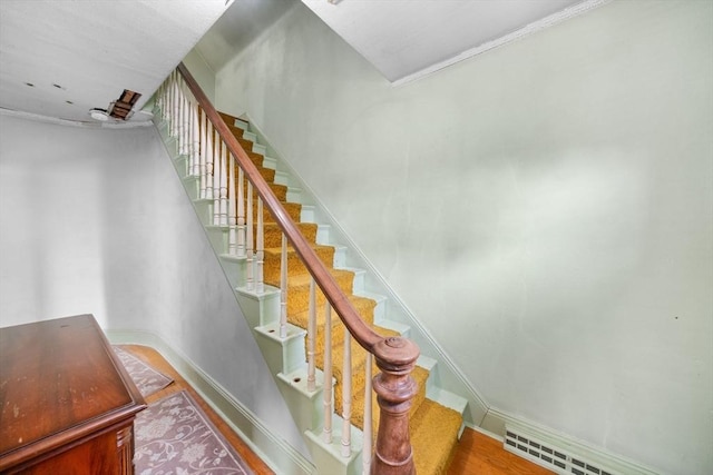 stairs featuring baseboards, visible vents, and wood finished floors