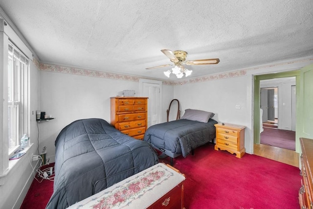 bedroom featuring a ceiling fan, a textured ceiling, and wood finished floors