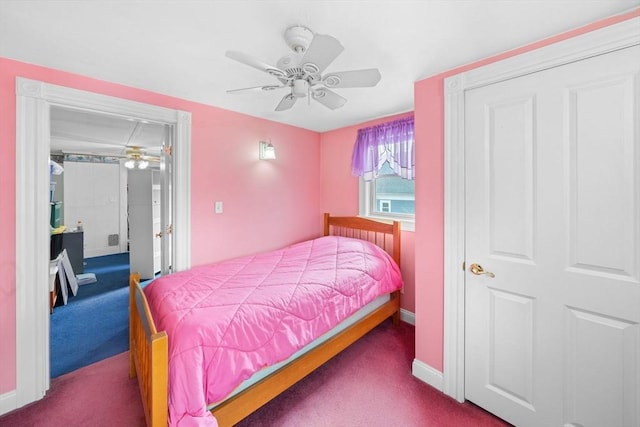 carpeted bedroom with a ceiling fan and baseboards