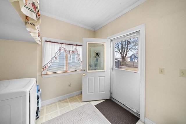 entryway with washer / dryer, crown molding, baseboards, and tile patterned floors