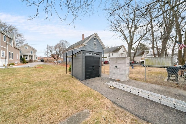 exterior space featuring aphalt driveway and fence