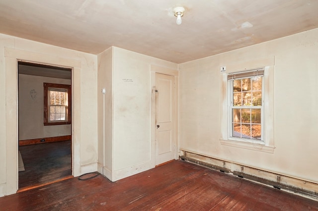 unfurnished room with dark hardwood / wood-style flooring