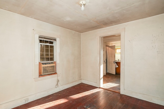 empty room with cooling unit and dark wood-type flooring