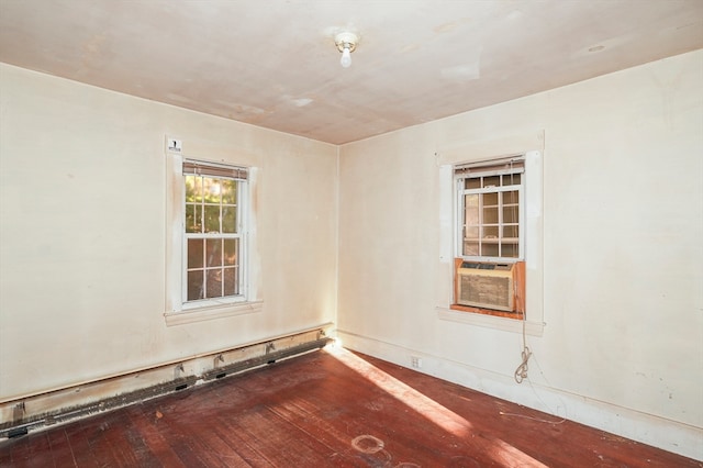 unfurnished room featuring cooling unit and wood-type flooring