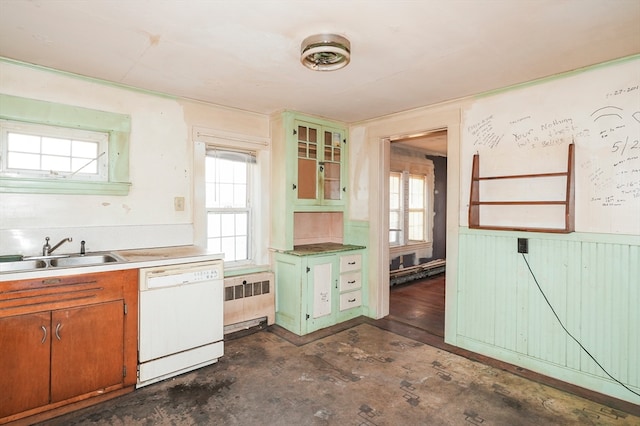 kitchen with dishwasher, baseboard heating, radiator, and sink