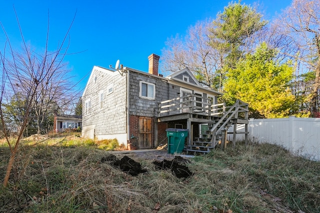 back of house featuring a deck