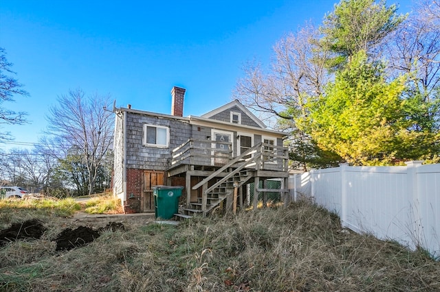 back of house featuring a deck