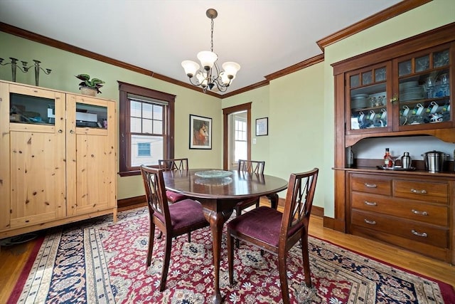 149 Milton Ave, Boston, MA 02124 - dining area with wood finished floors, a chandelier, baseboards, and ornamental molding