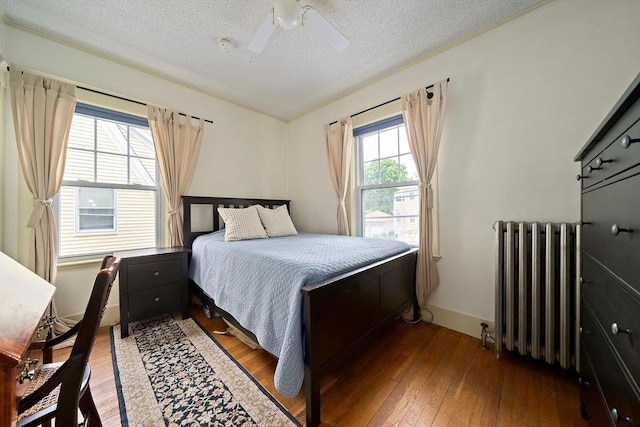 149 Milton Ave, Boston, MA 02124 - bedroom featuring radiator, hardwood / wood-style flooring, a textured ceiling, ceiling fan, and baseboards