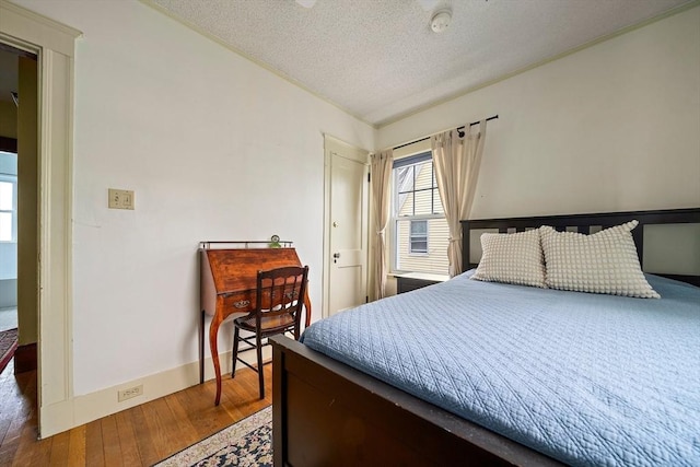 149 Milton Ave, Boston, MA 02124 - bedroom featuring a textured ceiling, wood finished floors, and baseboards