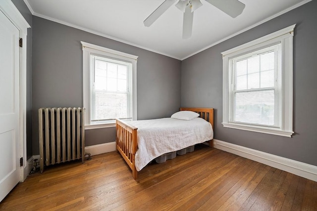 149 Milton Ave, Boston, MA 02124 - bedroom featuring radiator heating unit, wood-type flooring, ornamental molding, baseboards, and a ceiling fan