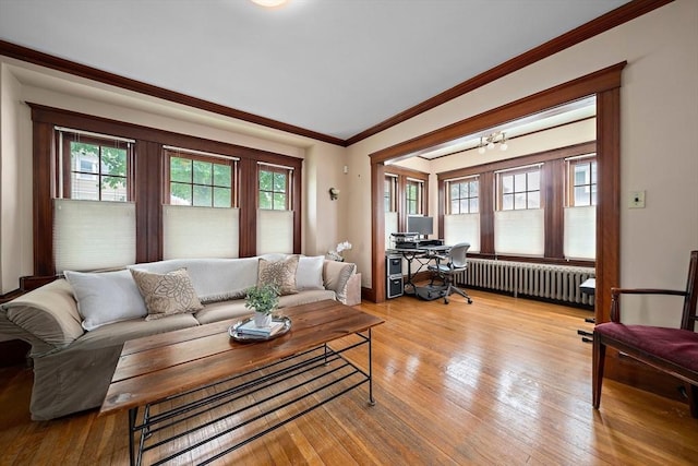 149 Milton Ave, Boston, MA 02124 - living room with radiator, an office area, ornamental molding, wood finished floors, and a chandelier